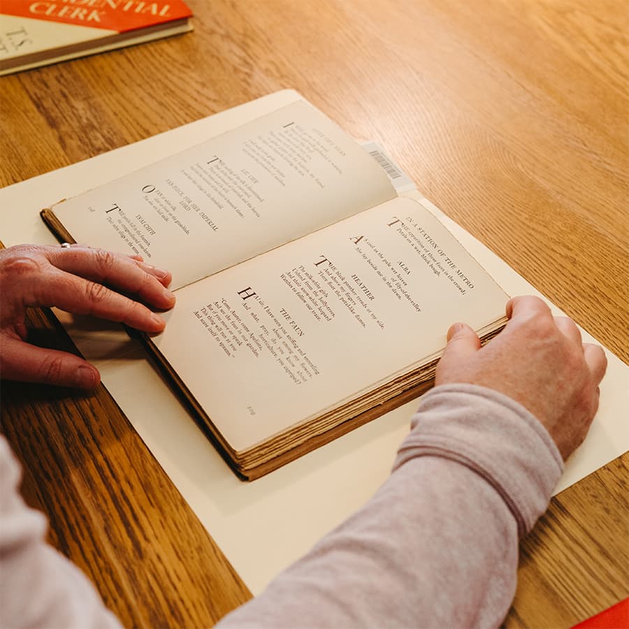 Student reading historic book.
