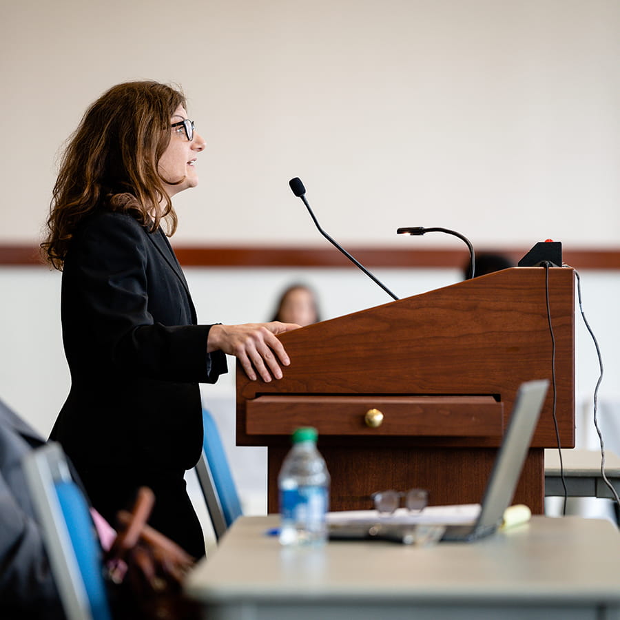 woman in business attire speaking with judge at the court of appeals