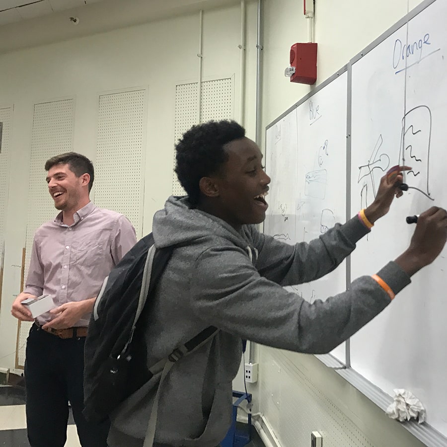 pre-collegiate faculty student at whiteboard